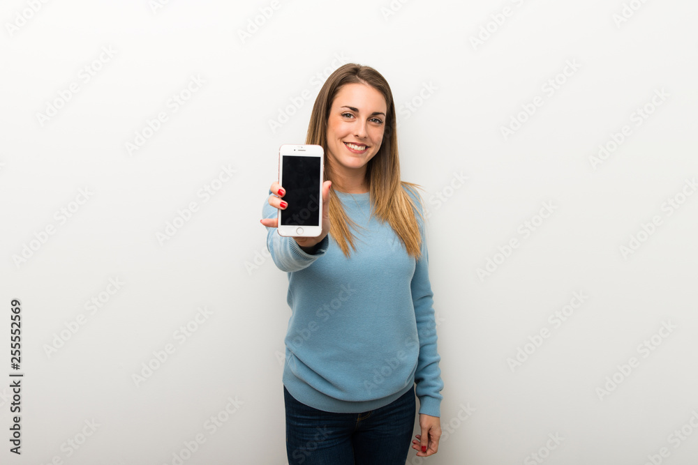 Blonde woman on isolated white background showing the mobile Blonde woman on isolated white background showing the mobile