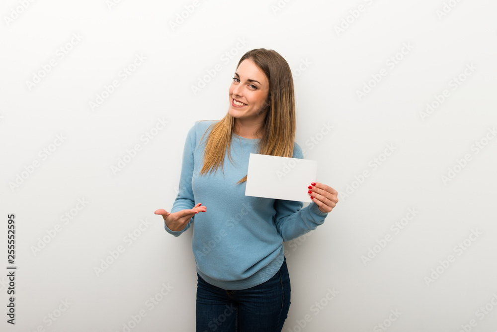 Blonde woman on isolated white background holding an empty placard for insert a concept Blonde woman on isolated white background holding an empty placard for insert a concept
