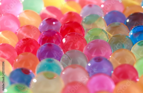 Water coloured gel balls. Polymer gel. Silica gel. Balls of blue hydrogel. Crystal liquid ball with reflection. Texture background. Close up macro photo