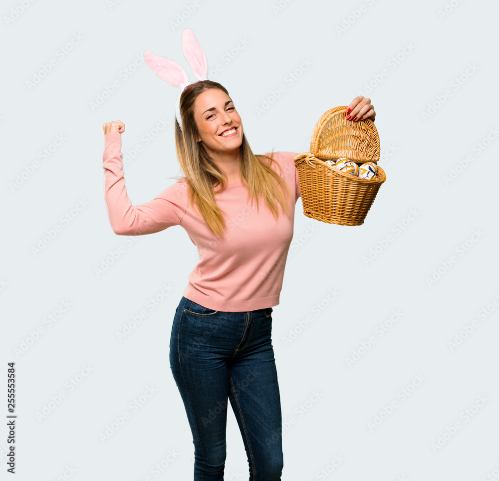 Εκτύπωση καμβά Young woman wearing bunny ears for Easter holidays celebrating a victory in winn