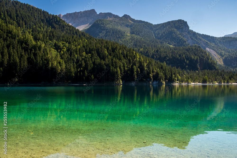 Fototapeta Beautiful view of Lake Tovel, the largest of all natural lakes in Trentino in the Adamello Brenta Park