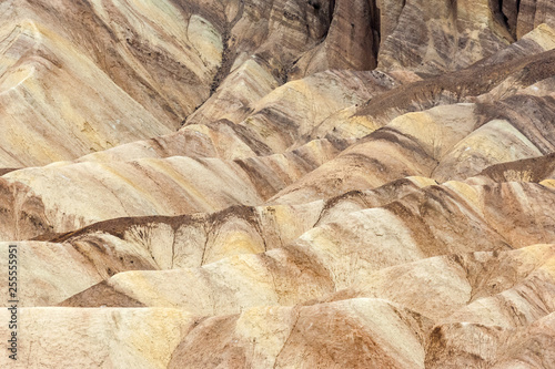 Multicolored background of eroded geological formations in Zabriskie Point, Death Valley national park, California, USA