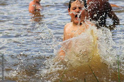 Happy boy having fun in pond.