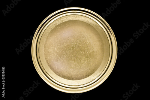 Golden jar lid isolated on black background