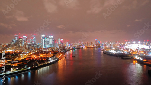 Aerial drone night shot from iconic Canary Wharf skyscrapers business area, Isle of Dogs, London, United Kingdom, 