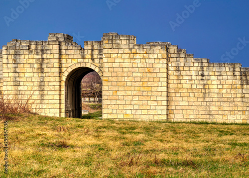 Solid stone wall and entrance of ancient fortress