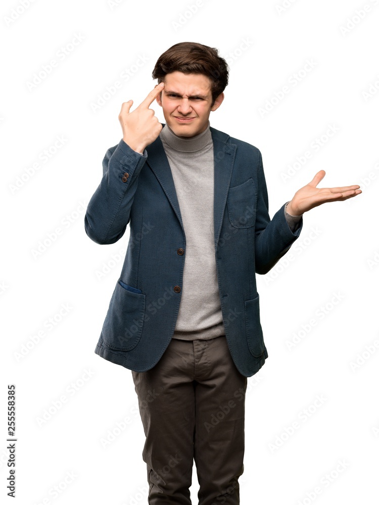 Teenager man with turtleneck making the gesture of madness putting finger on the head over isolated white background Teenager man with turtleneck making the gesture of madness putting finger on the head over isolated white background