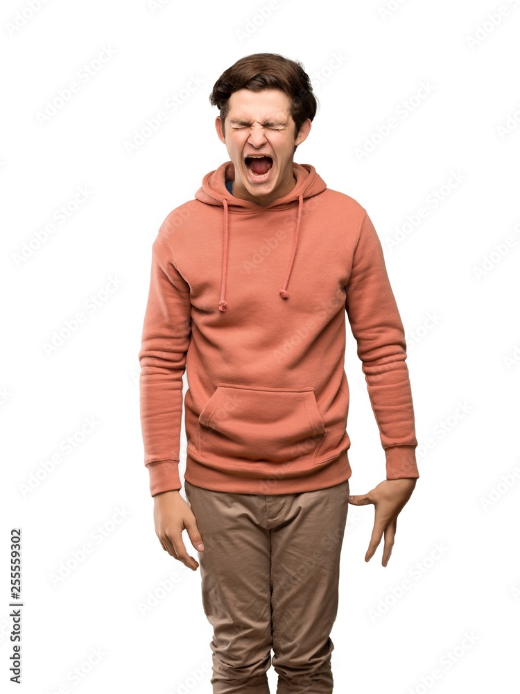 Teenager man with sweatshirt shouting to the front with mouth wide open over isolated white background Teenager man with sweatshirt shouting to the front with mouth wide open over isolated white background