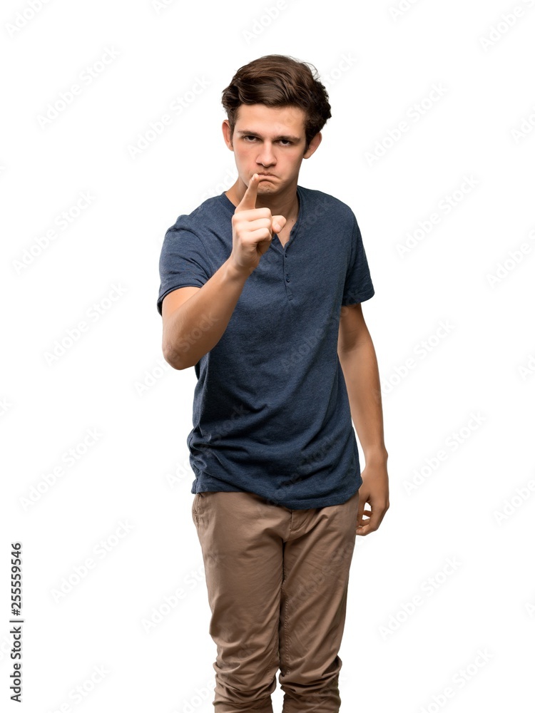 Teenager man frustrated and pointing to the front over isolated white background Teenager man frustrated and pointing to the front over isolated white background