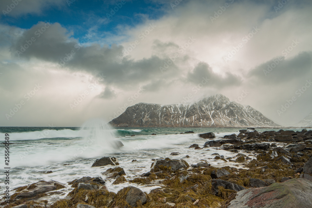 Rocks falling into the sea near Skagsanden beach. Lofoten islands, Norway