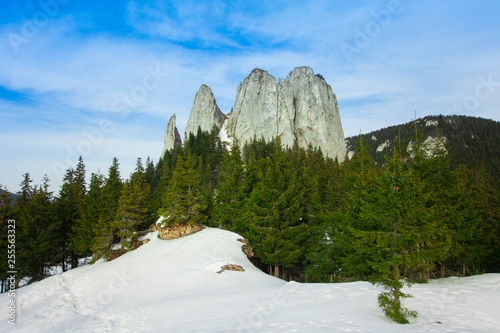 alpine landscape, mountain chalet and high cliffs, Piatra Singuratica, (Lonely Rock), Hasmasul Mare mountains in Transylvania, Romania photo