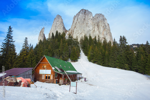 hut in rocky mountains, the Lonely Rock formation in Romania. Hasmas © Ioan Panaite