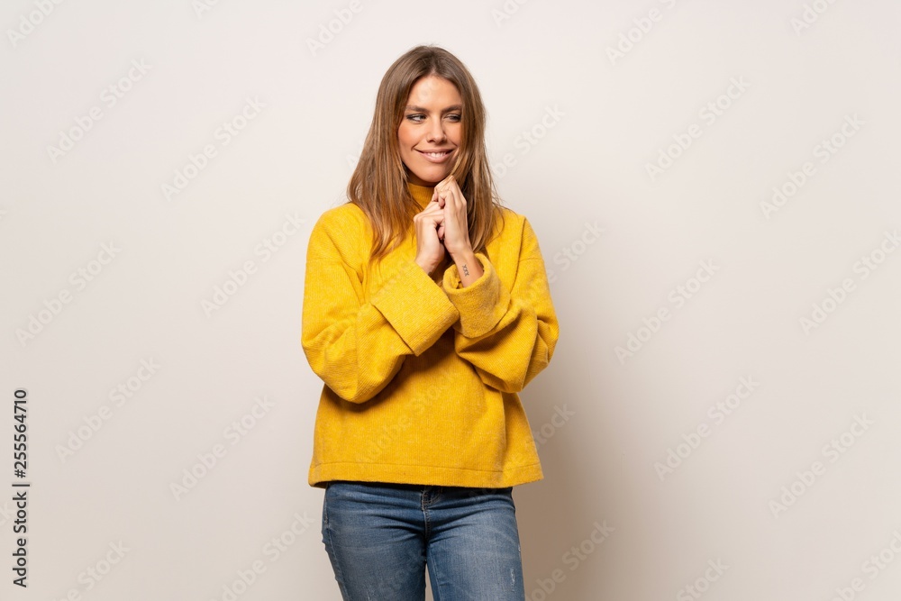 Woman with yellow sweater over isolated wall scheming something Woman with yellow sweater over isolated wall scheming something
