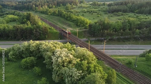 Close approach of rail road crane on the bridge through highway