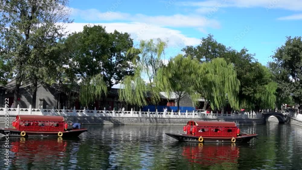 Sightseeing boats travel in the lake of the tourism area Rear Lake (Houhai in Chinese) of the city, Beijing, China Sightseeing boats travel in the lake of the tourism area Rear Lake (Houhai in Chinese) of the city, Beijing, China