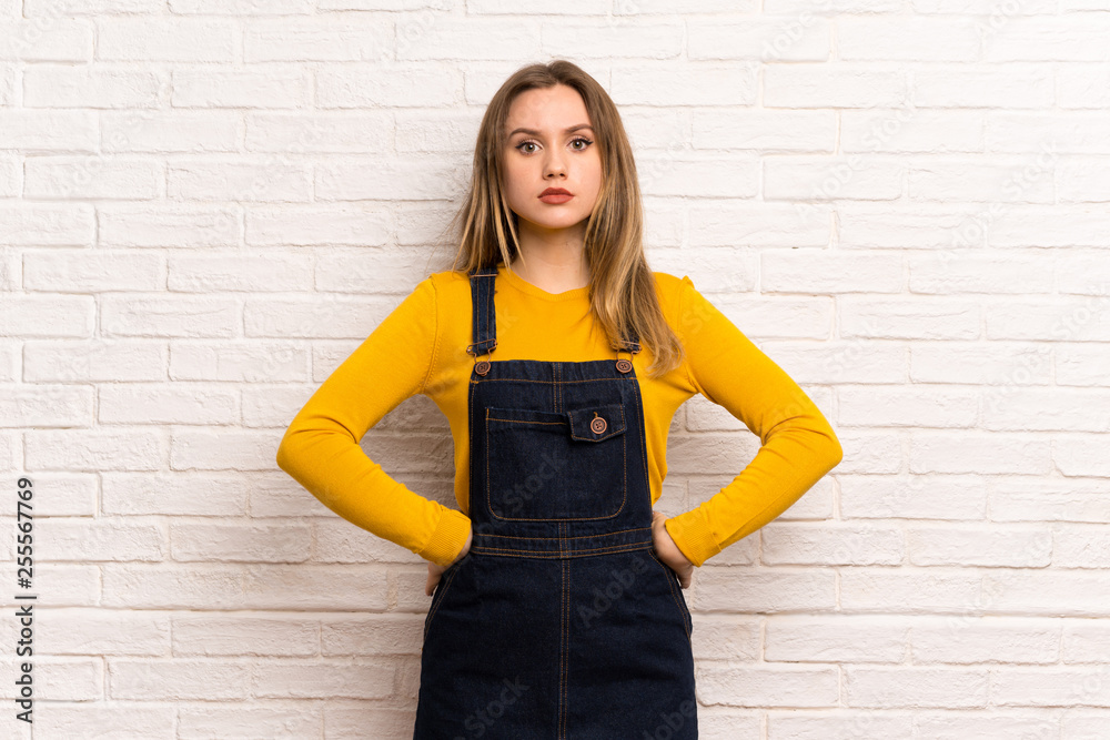 Teenager girl over white brick wall angry Teenager girl over white brick wall angry