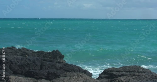 Waves Crashing in Behind Volcanic Rock in Hawaii in Slow Motion