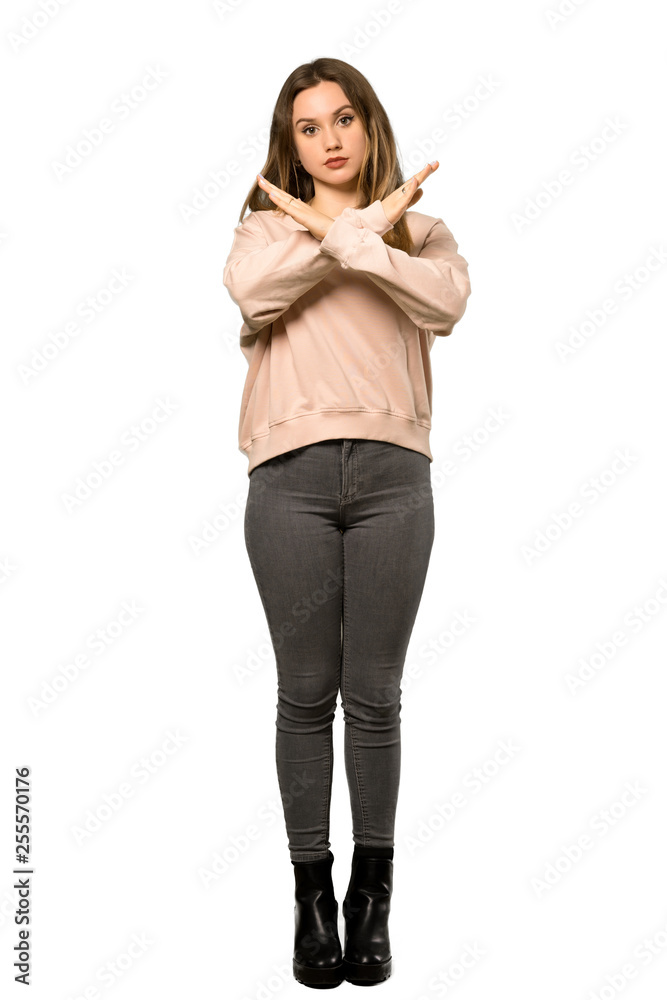 A full-length shot of a Teenager girl with pink sweater making NO gesture over isolated white background A full-length shot of a Teenager girl with pink sweater making NO gesture over isolated white background