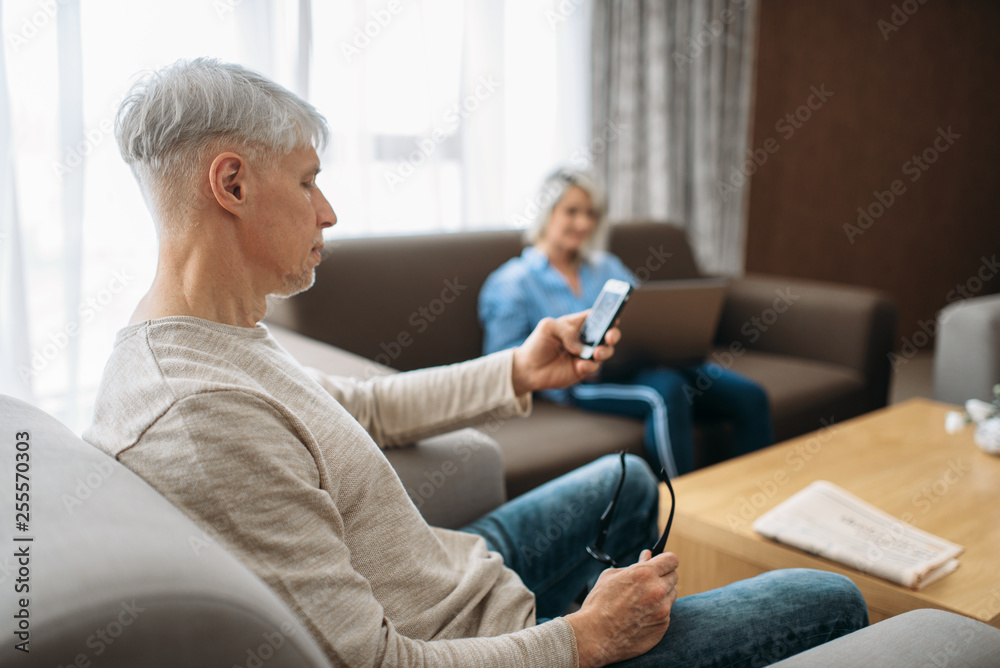 Cheerful adult love couple resting at home