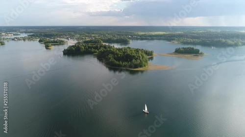 Yacht floats on water surface in the lake. Storm is coming in the horizon