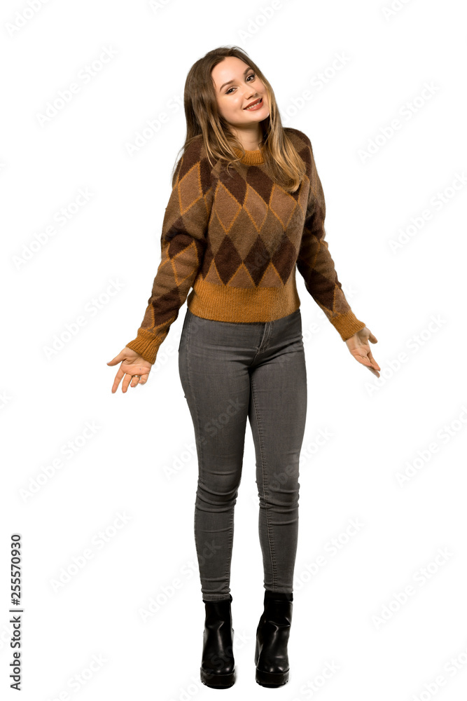 A full-length shot of a Teenager girl with brown sweater smiling over isolated white background A full-length shot of a Teenager girl with brown sweater smiling over isolated white background