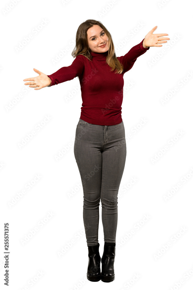 A full-length shot of a Teenager girl with turtleneck presenting and inviting to come with hand over isolated white background A full-length shot of a Teenager girl with turtleneck presenting and inviting to come with hand over isolated white background