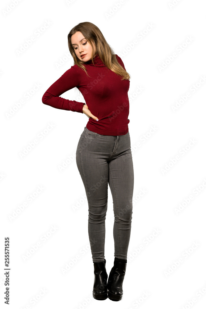 A full-length shot of a Teenager girl with turtleneck suffering from backache for having made an effort over isolated white background A full-length shot of a Teenager girl with turtleneck suffering from backache for having made an effort over isolated white background