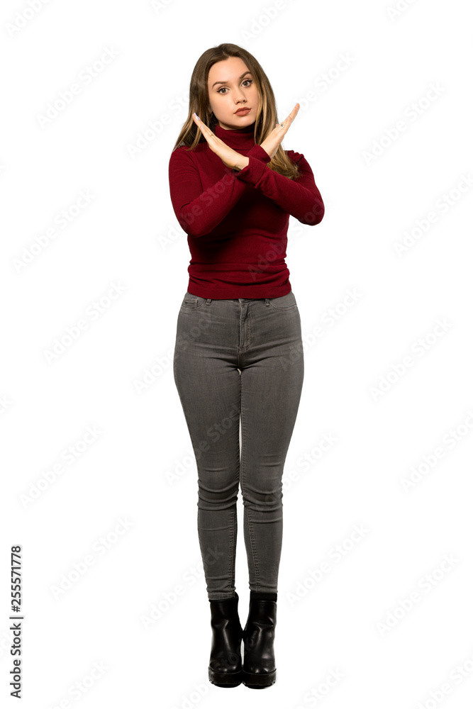 A full-length shot of a Teenager girl with turtleneck making NO gesture over isolated white background A full-length shot of a Teenager girl with turtleneck making NO gesture over isolated white background
