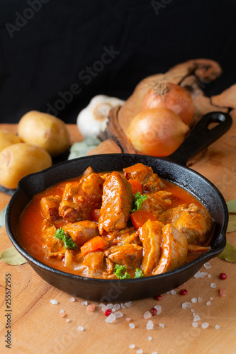 Food concept french classic veal stew marengo de veau in skillet iron cast with copy space photo