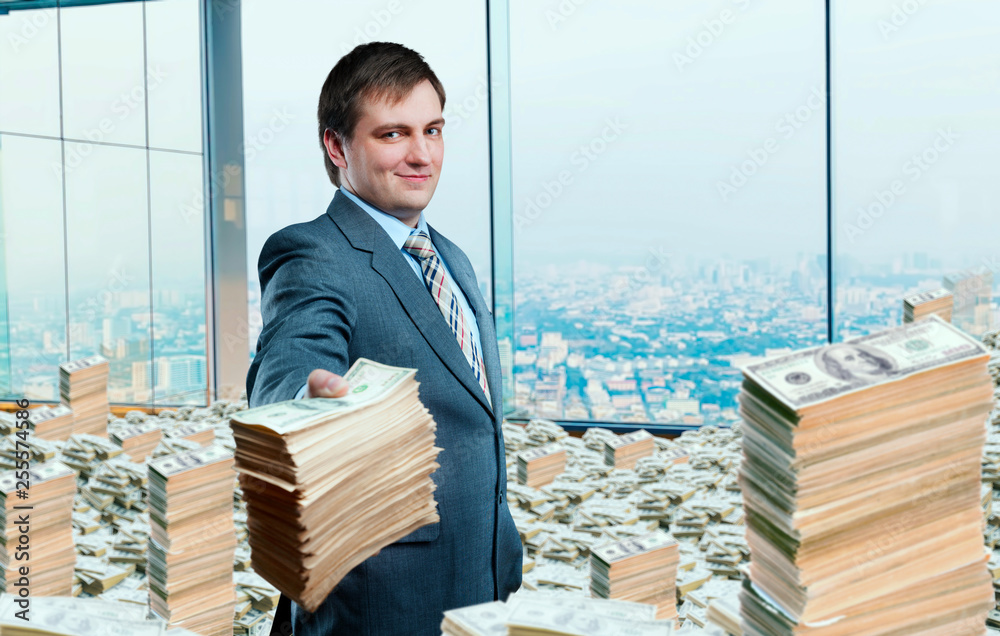 © Nomad_Soul - Young businessman holding out a wad of money © Nomad_Soul - Young businessman holding out a wad of money