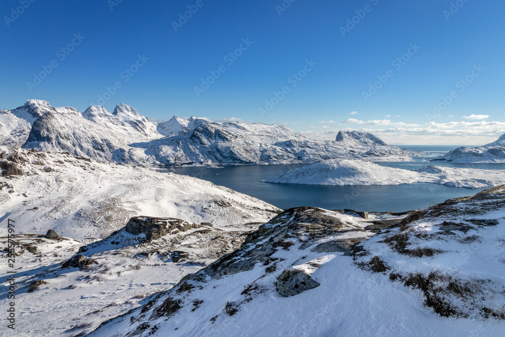 Panoramic view of a part of the Lofoten Islands in Norway on a winter hike to Mount Ryten