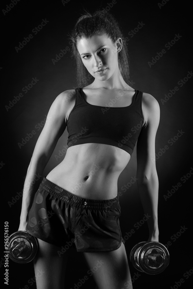 fitness woman in doing exercises with dumbells. fitness woman in doing exercises with dumbells.