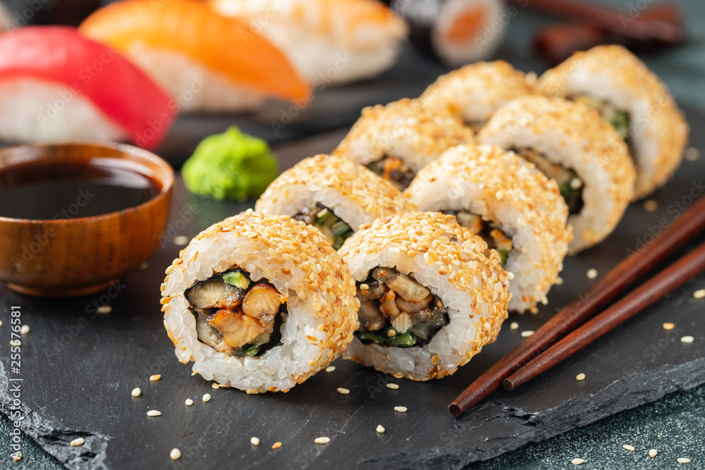 Sushi roll with smoked eel, cucumber, avocado. Sushi roll with smoked eel, cucumber, avocado.