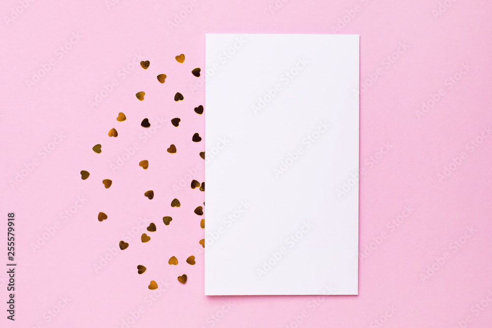 White gretting card with golden love confetti on pink color paper background minimal style White gretting card with golden love confetti on pink color paper background minimal style