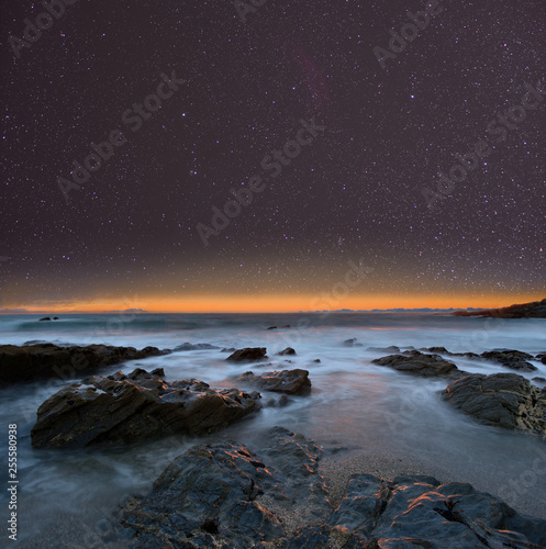 Night sky from a rocky beach. Cornwall, UK.