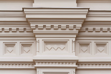 Fragment of the relief frieze with geometric pattern  on the wall of beige stone ancient building