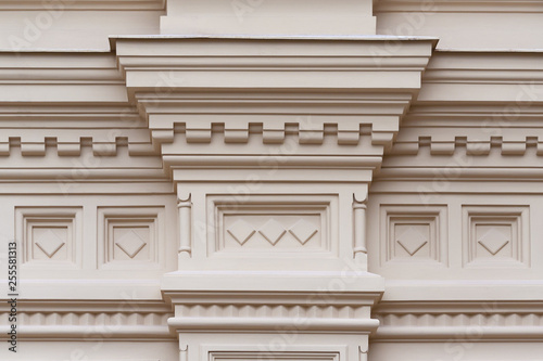Fragment of the relief frieze with geometric pattern  on the wall of beige stone ancient building