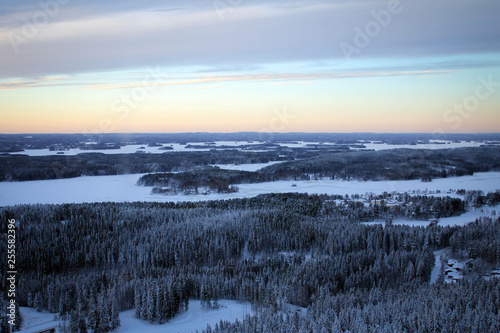 Amazing panoramic landscape of winter pine forest from top of Puijo Tower, Kuopio, Finland © free2trip