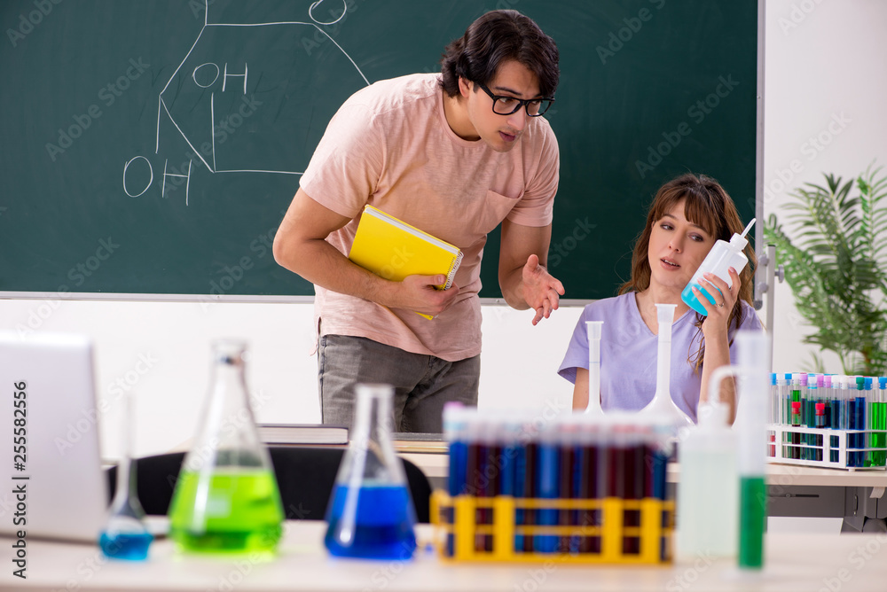 Two chemists students in classroom Two chemists students in classroom