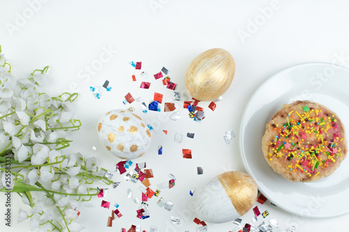 Happy Easter. Painted eggs on white background. Easter Cake - Russian and Ukrainian Traditional Kulich, Paska Easter Bread. Top view. Copy space for text.