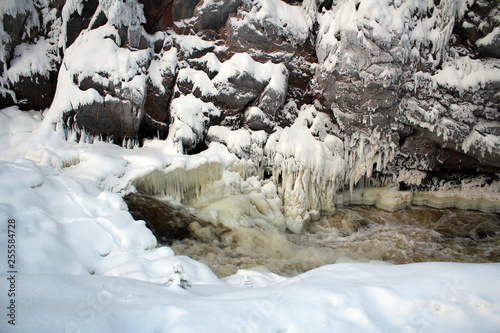 Frozen Patoniva River and red rocks of Oulanka National park, Finland