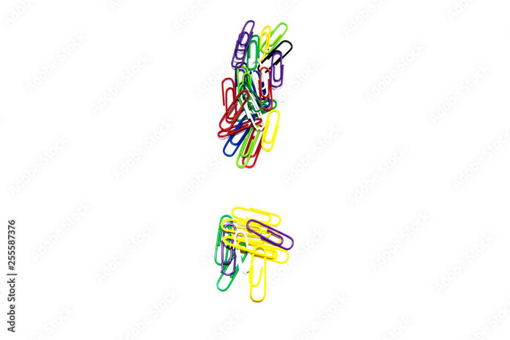 Exclamation mark from color clips, with soft blur at the bottom, on a white background.