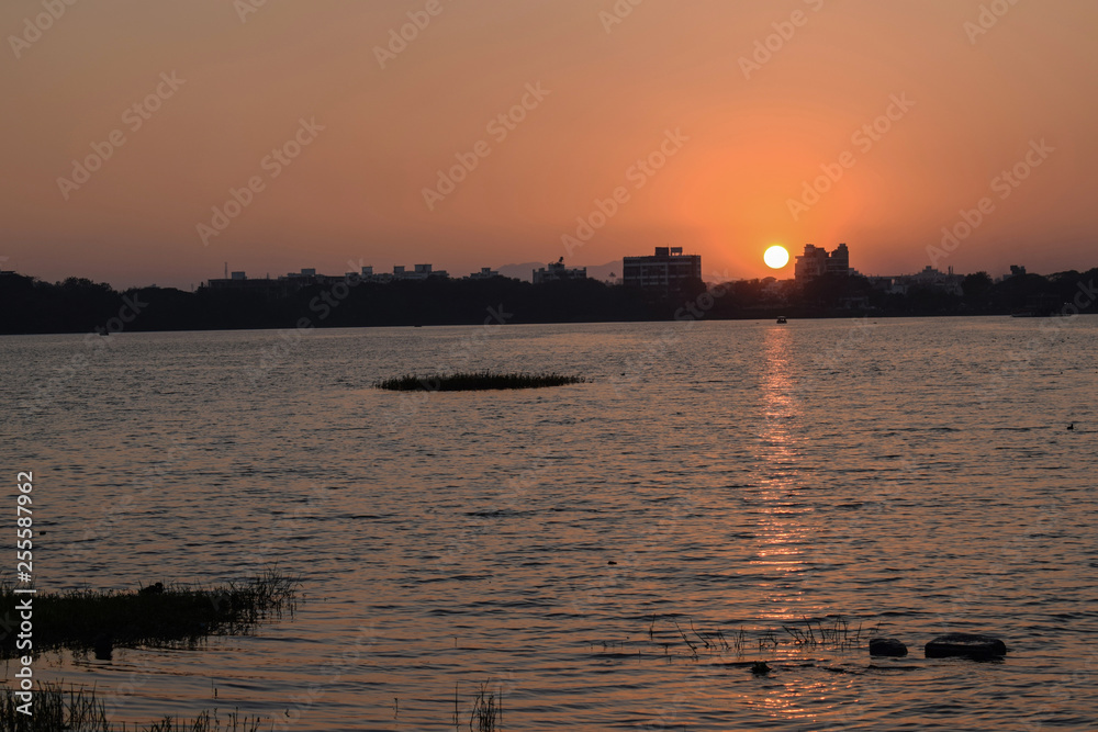 Fototapeta premium beautiful hot and red sunrise in the city of India