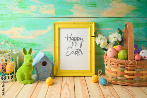 Photo frame or artwork display mock up on wooden table with easter decorations.