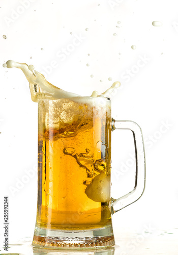 Pouring light beer in a beer mug, it turns out foam and spray