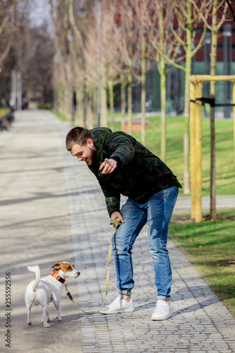 Young man with his dog, Jack Russell Terrier
