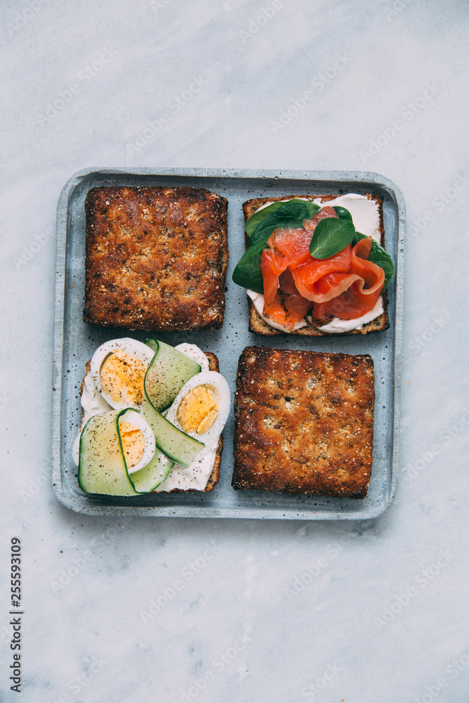 Smorrebrod - danish open sandwich with fish, vegetables, cheese on marble background. Top view with copy space Smorrebrod - danish open sandwich with fish, vegetables, cheese on marble background. Top view with copy space