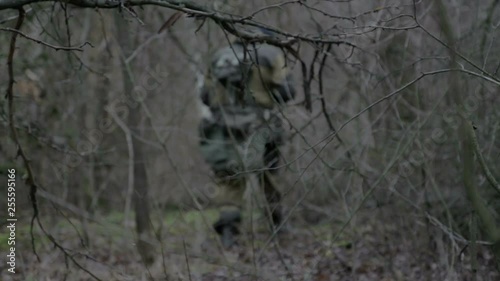 A group of scout saboteurs perform the task. An armed soldier without identification chevrons belonging to the army, terrorist, saboteur. photo