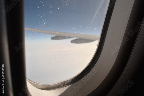 snowflake on plane window frame height in sky