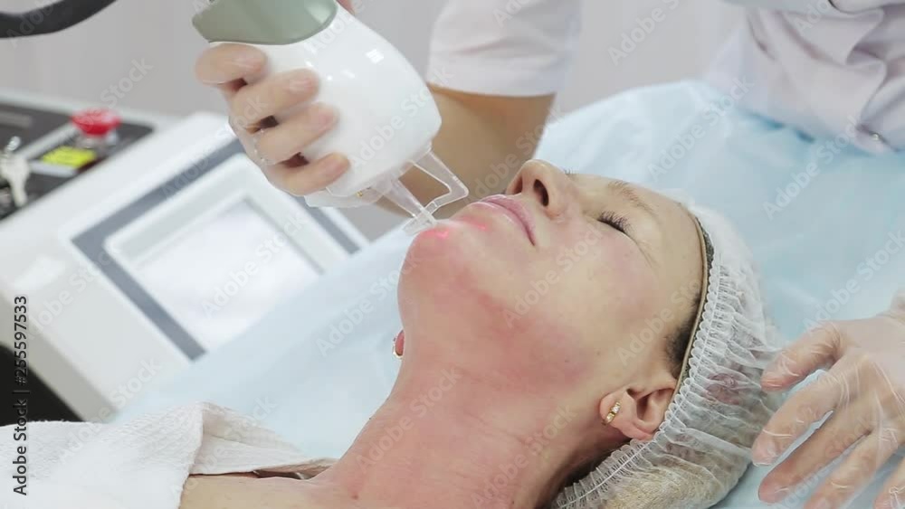 Resurfacing facial skin with a laser. Modern innovative medical equipment. laser face polishing in a cosmetology clinic Resurfacing facial skin with a laser. Modern innovative medical equipment. laser face polishing in a cosmetology clinic